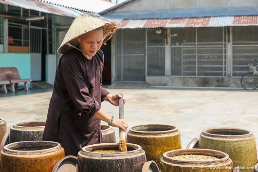 Nun Making Soy Sauce in the Mekong Delta, Vietnam