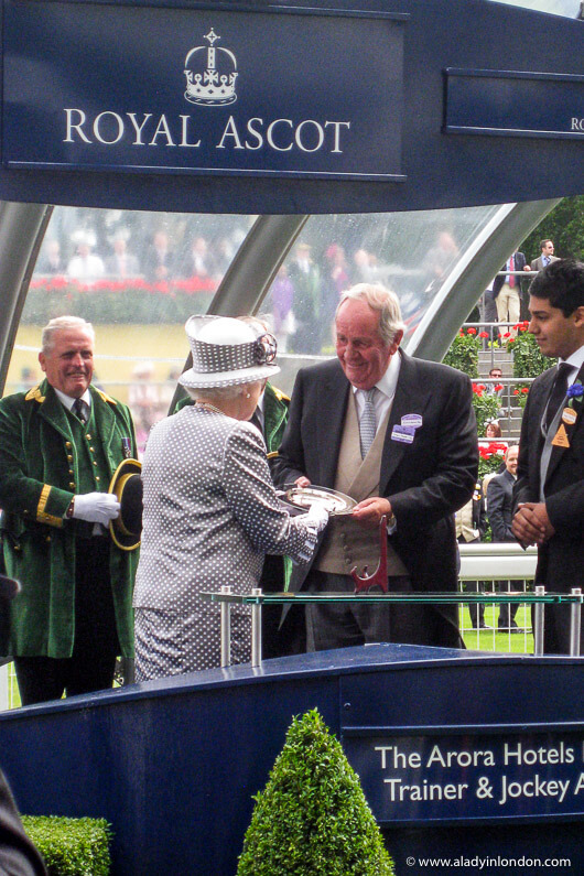 Queen Elizabeth II getting a trophy at Royal Ascot