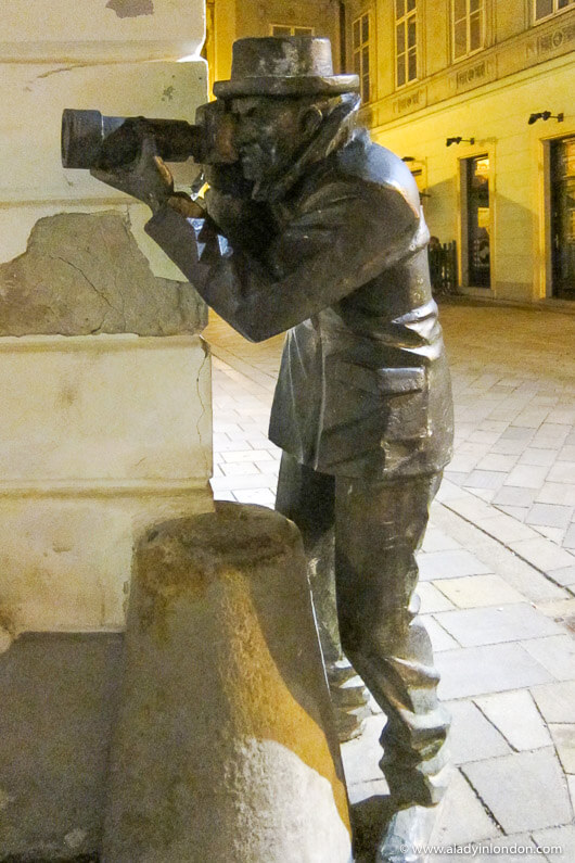 Sculpture of a man with a camera in Bratislava, Slovakia
