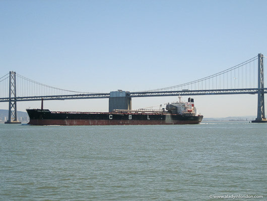 Container ship by the Bay Bridge in San Francisco, California