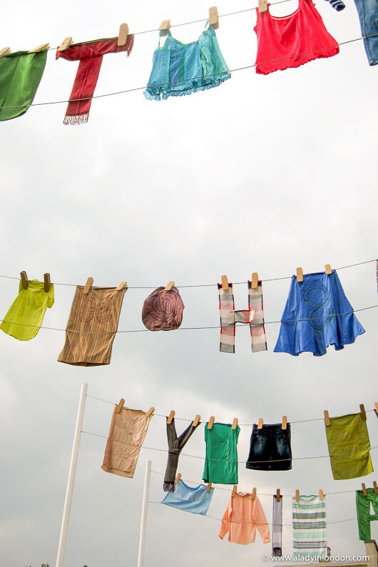 Clothing hanging from clothes lines at A Garden Party to Make a Difference in London