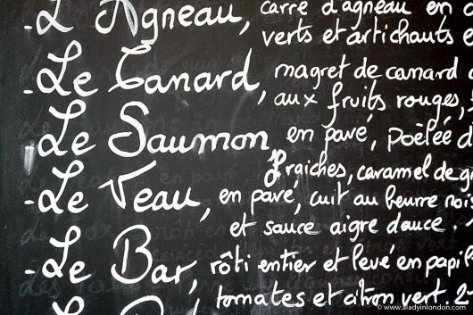 Chalkboard menu outside of a cafe in Paris, France