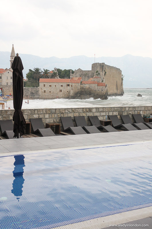 Hotel swimming pool and city walls in Budva, Montenegro