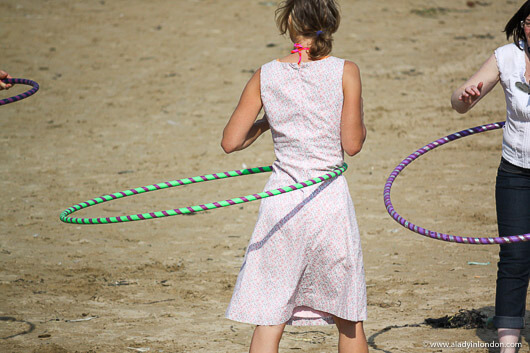 Hula hooping on the beach in Cornwall