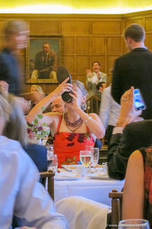 Drinking out of a shoe at a wedding in Oxford, England
