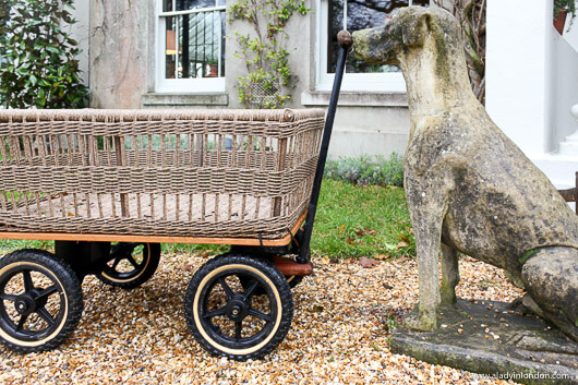 Stone dog sculpture in front of The Pig, New Forest, UK