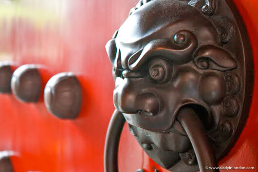 Red door with a lion at the Buddha Tooth Relic Temple in Singapore