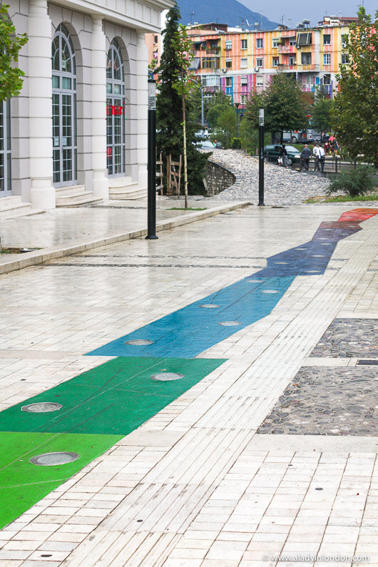 Colorful walkway with street art and buildings in Tirana