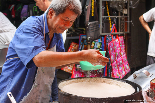 Man Cooking at a Street Food market in Kuala Lumpur