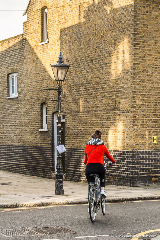 Girl Wearing London Street Style on a Bicycle in Hackney