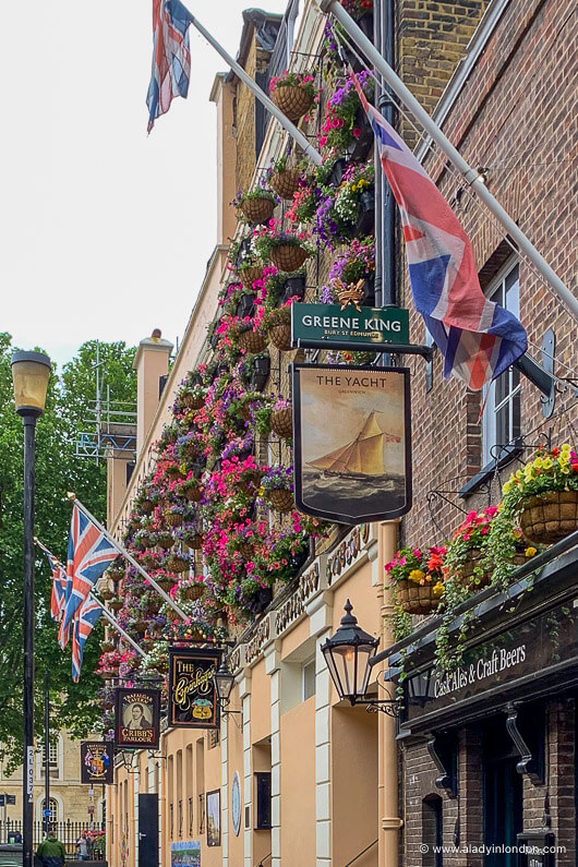 Greenwich pub with flowers on the facade